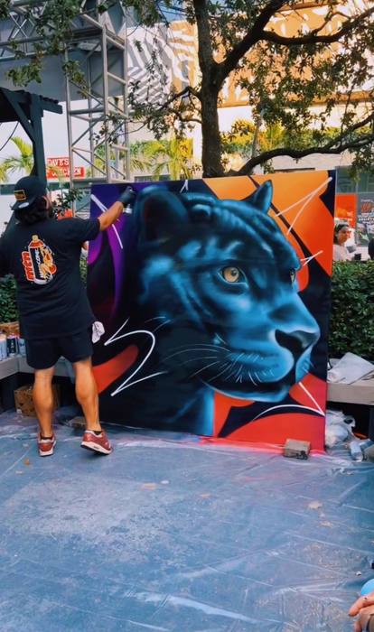 DREPS live painting a Florida Panthers themed mural at an event